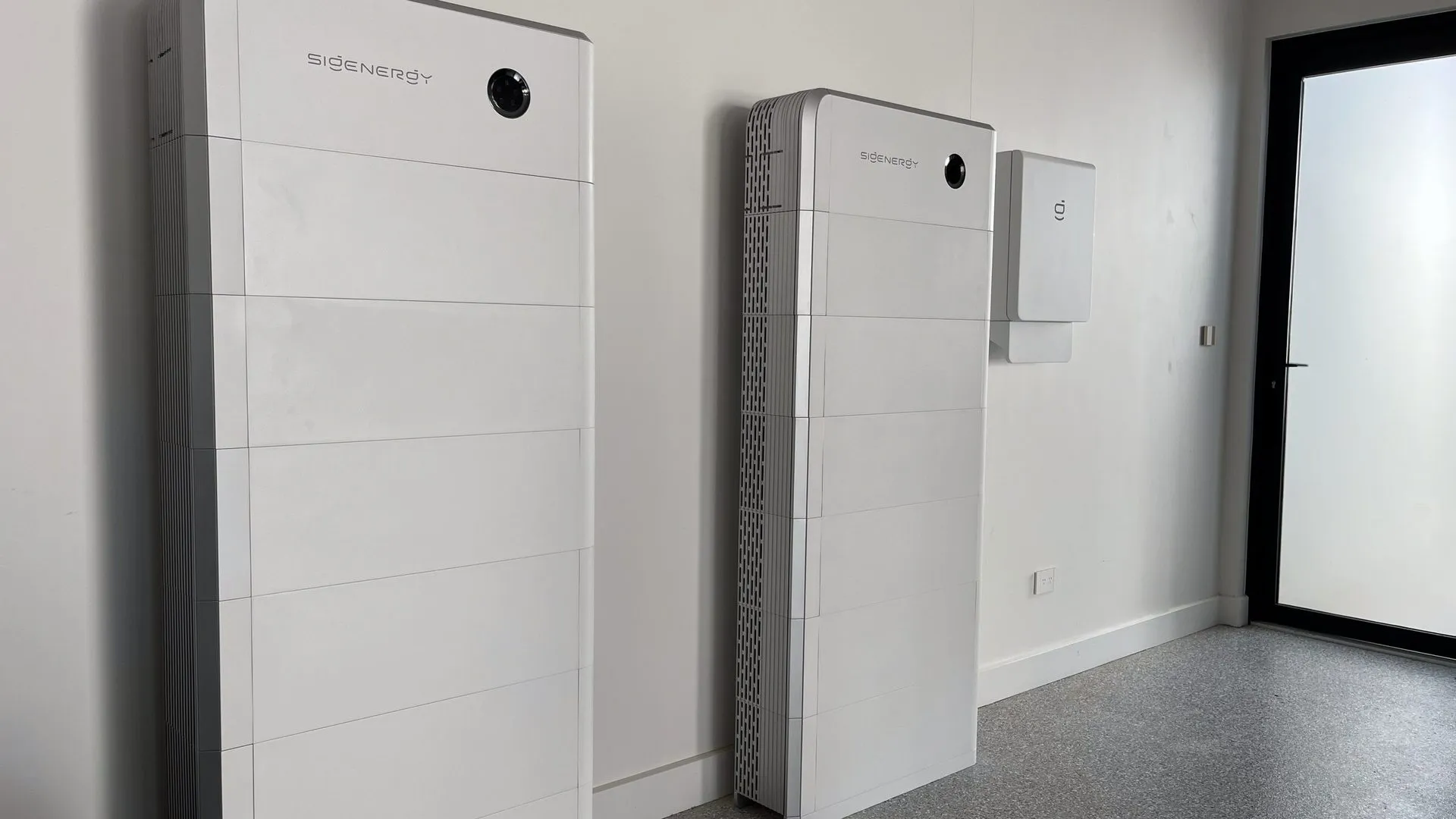 Solar panels on a metal roof with wall-mounted electrical enclosure