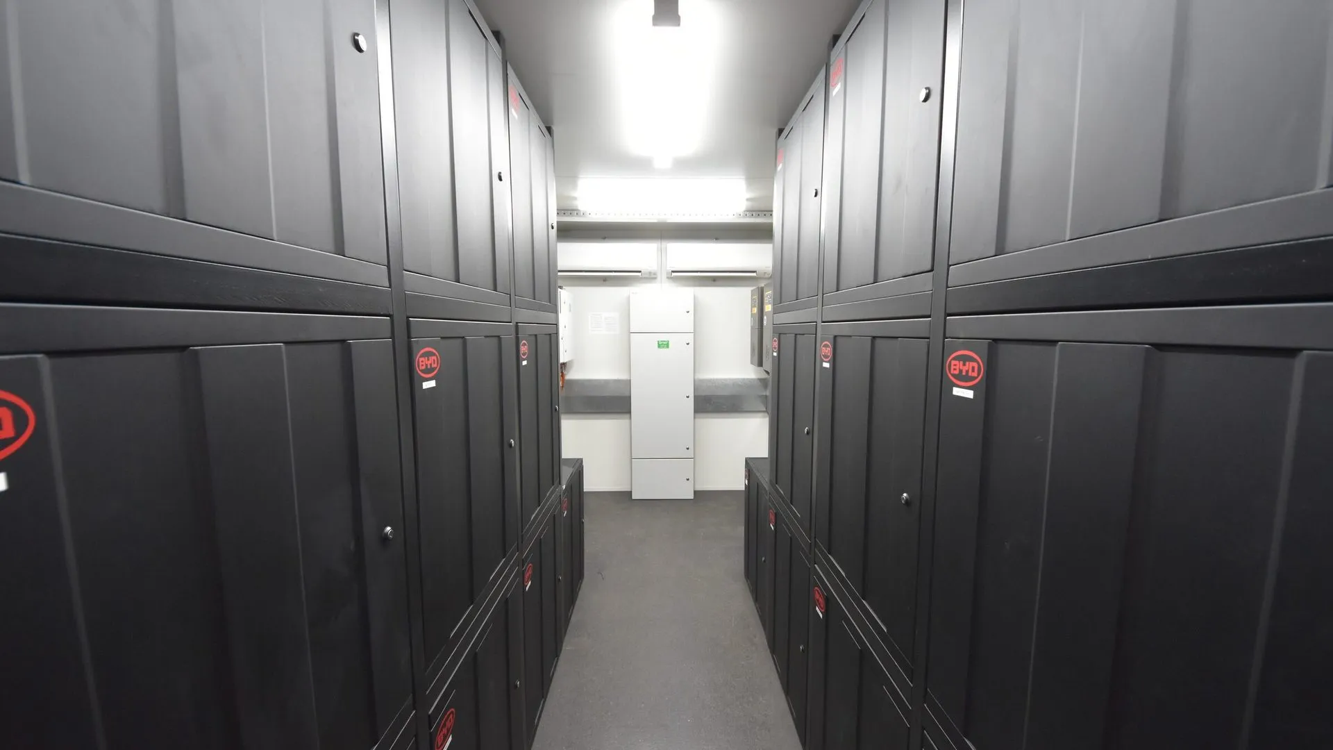 Rows of battery cabinets inside an off-grid battery container
