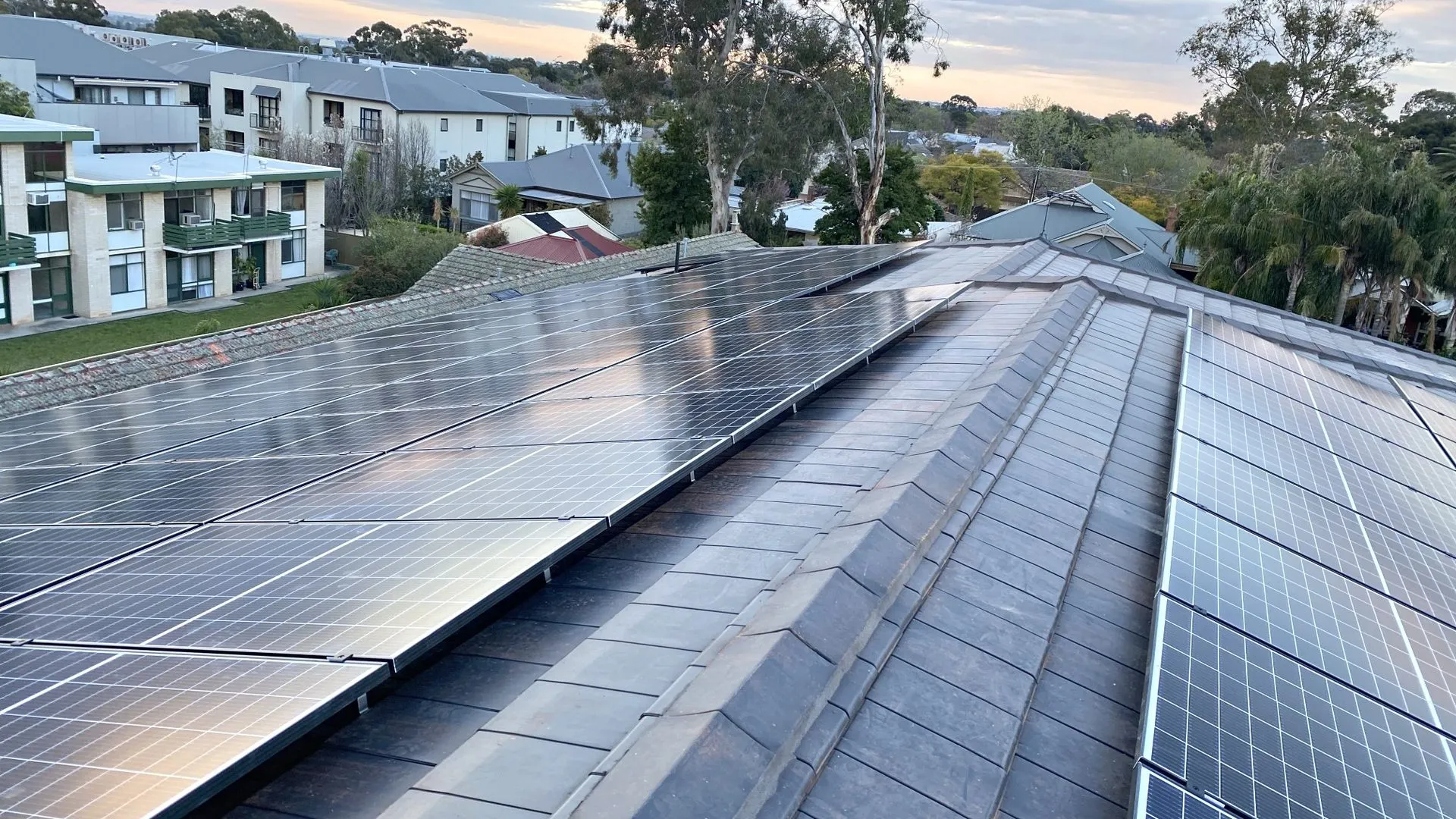 Rooftop solar panels on a tiled home roof in suburban Adelaide