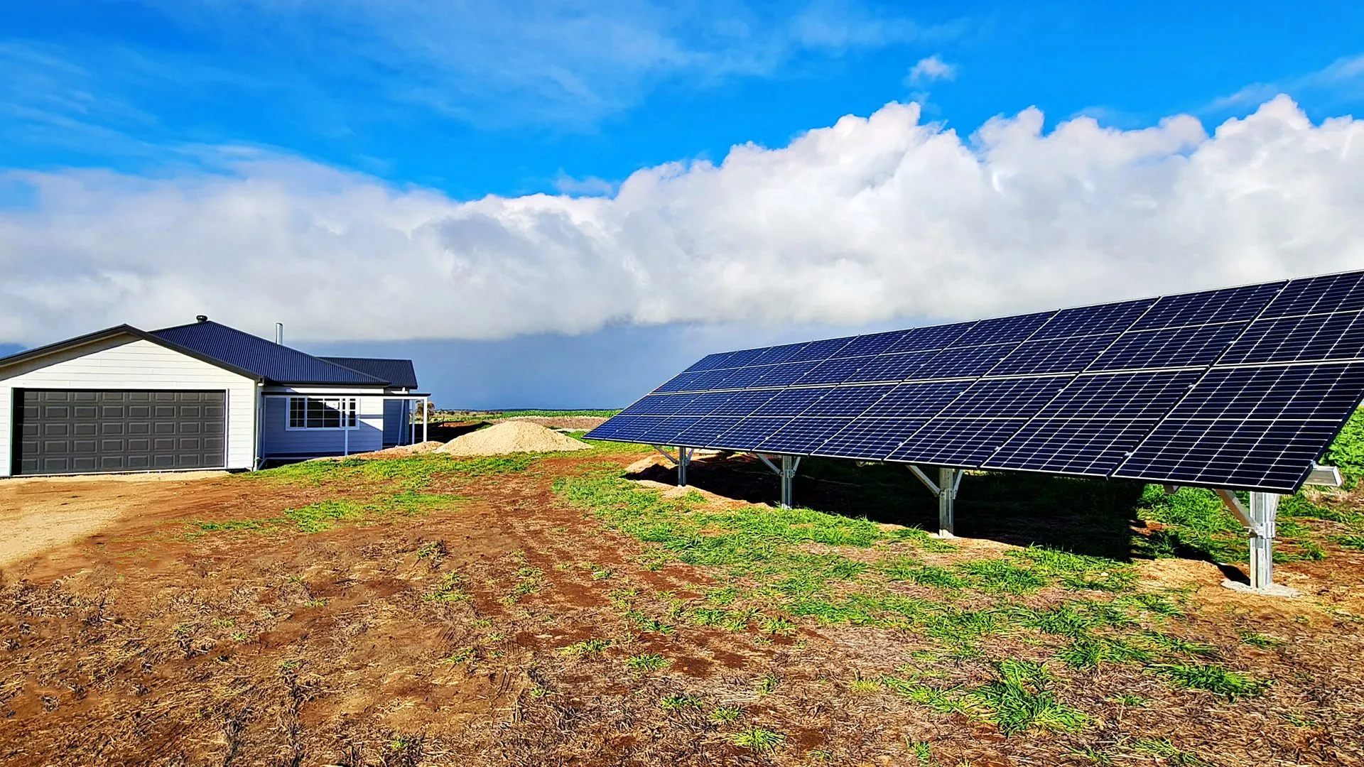 Off-grid home with a ground-mounted solar array on a rural property
