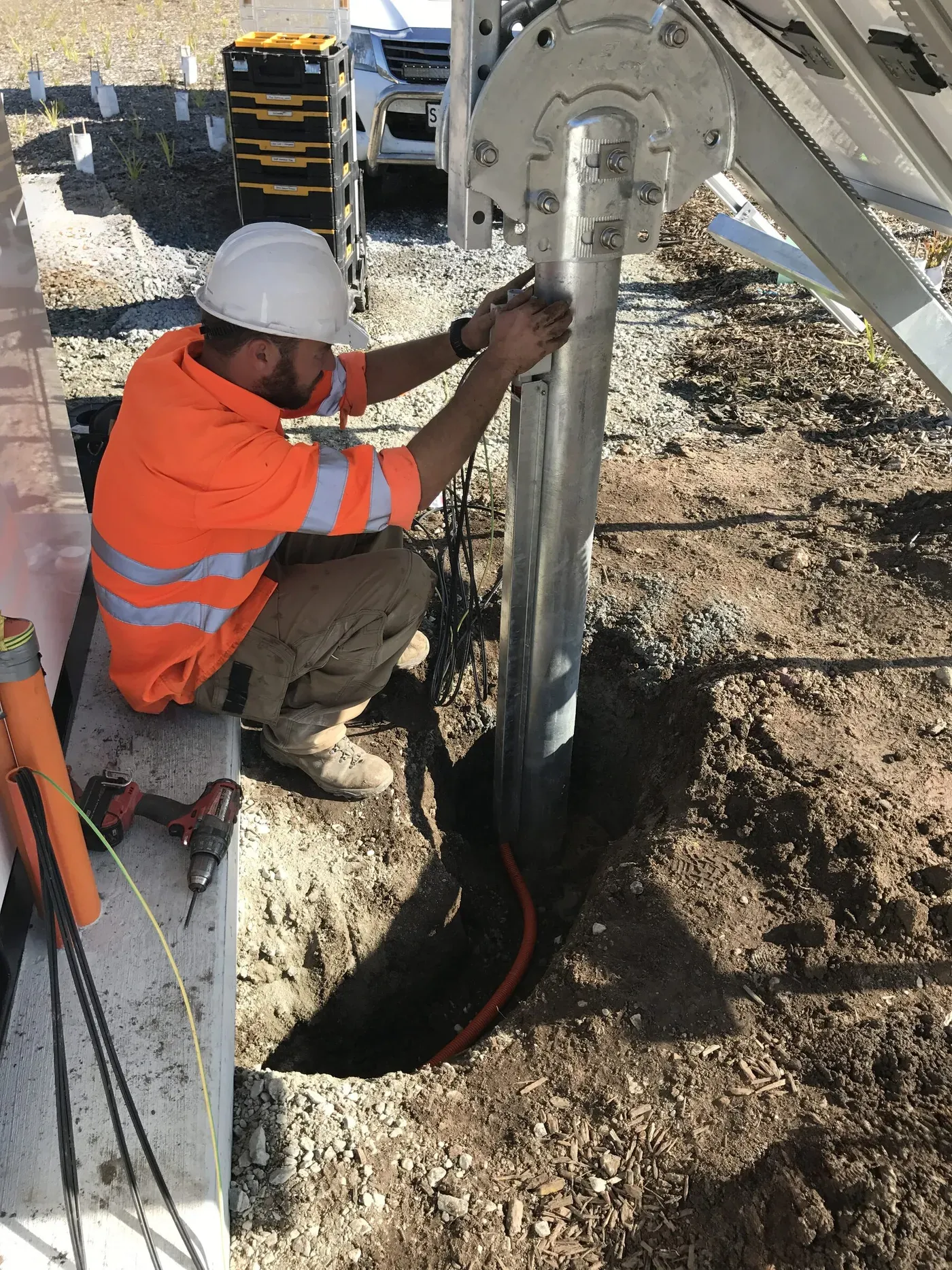 Off-Grid Energy installer wiring a ground-mounted solar array