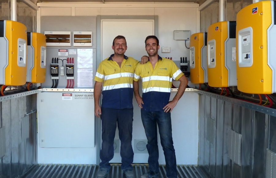 Off-Grid Energy's Hugh Driscoll & Sean LePoidevin inside a containerised mini-grid system